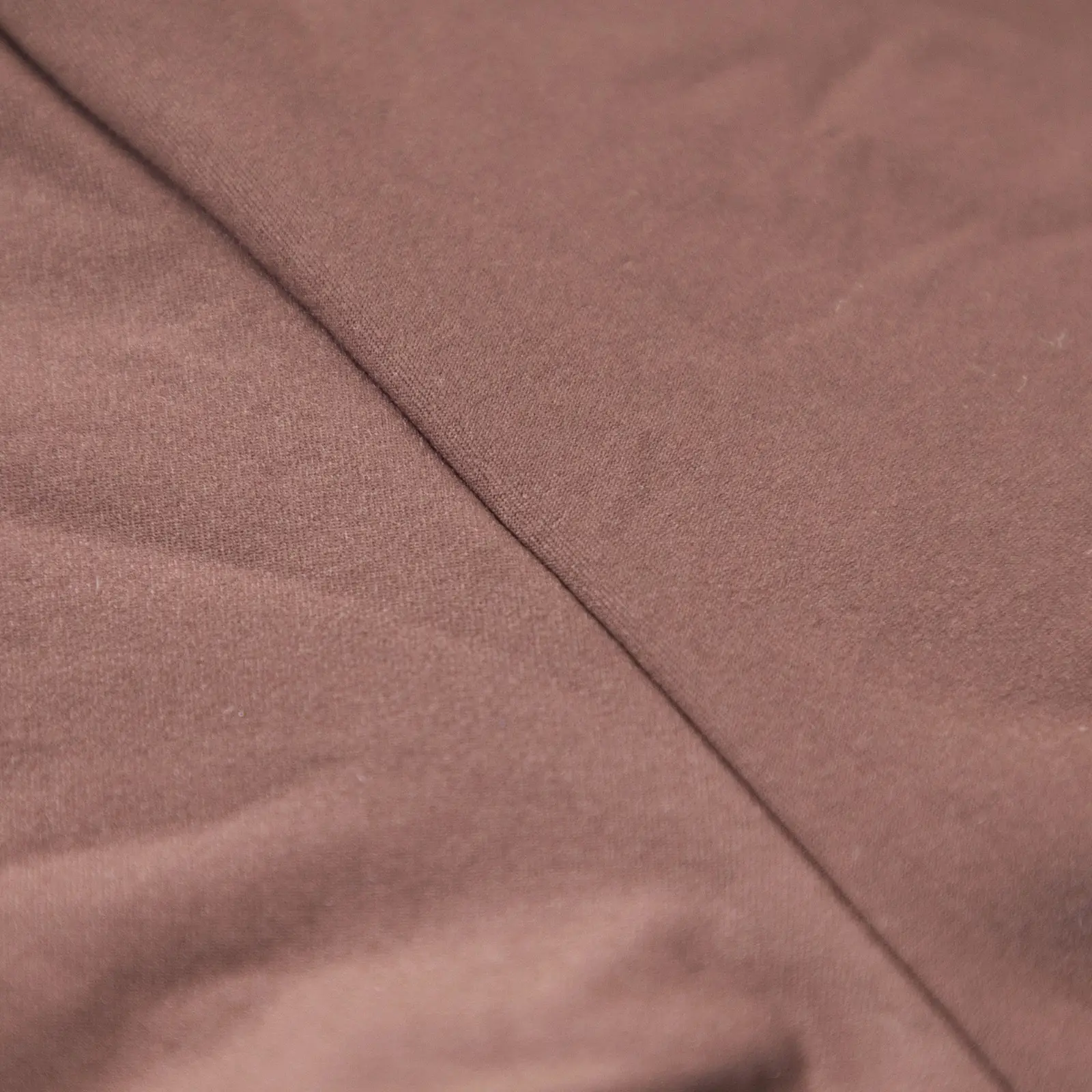 Close-up of brown bodysuit seam.