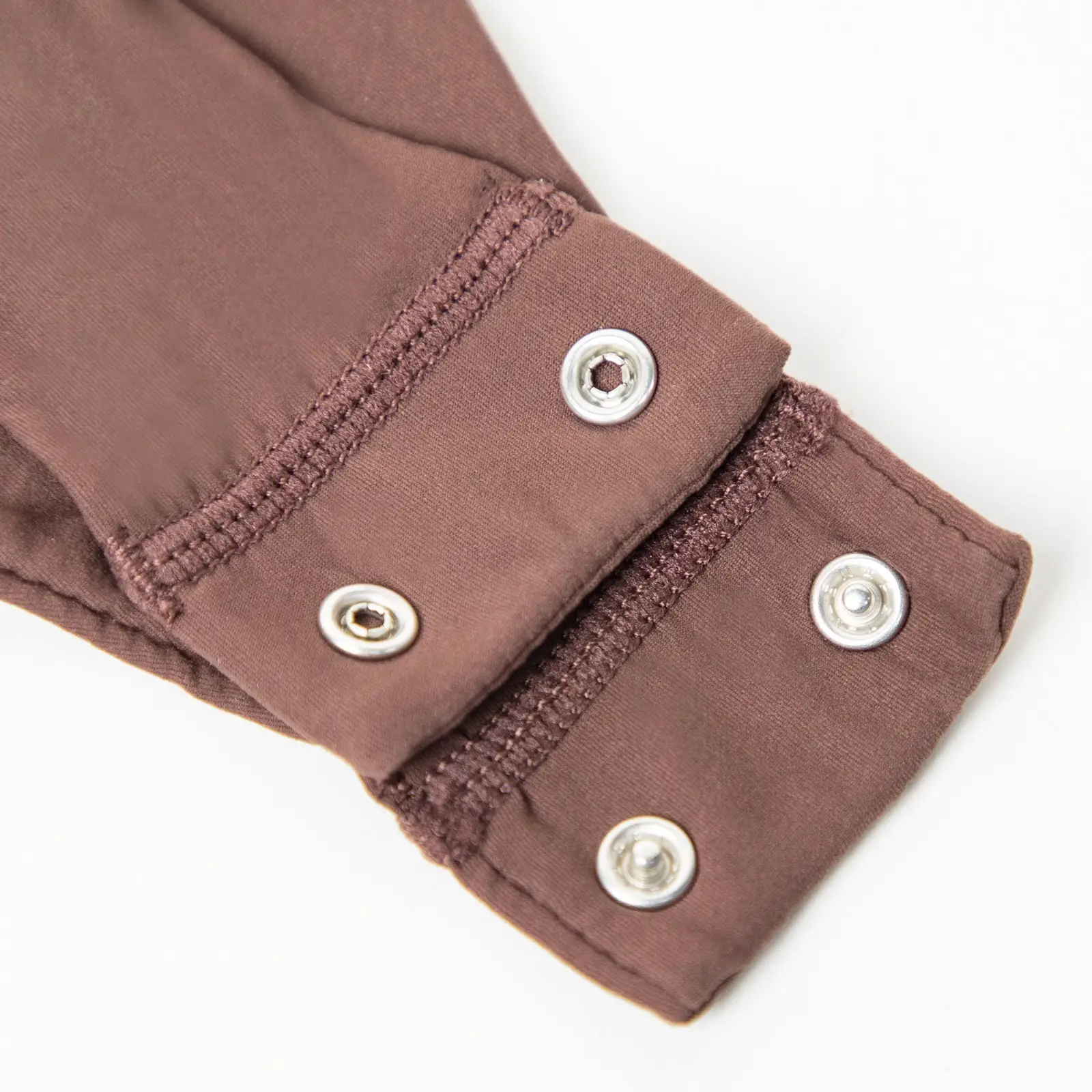 Close-up of brown bodysuit thong snap-close system.