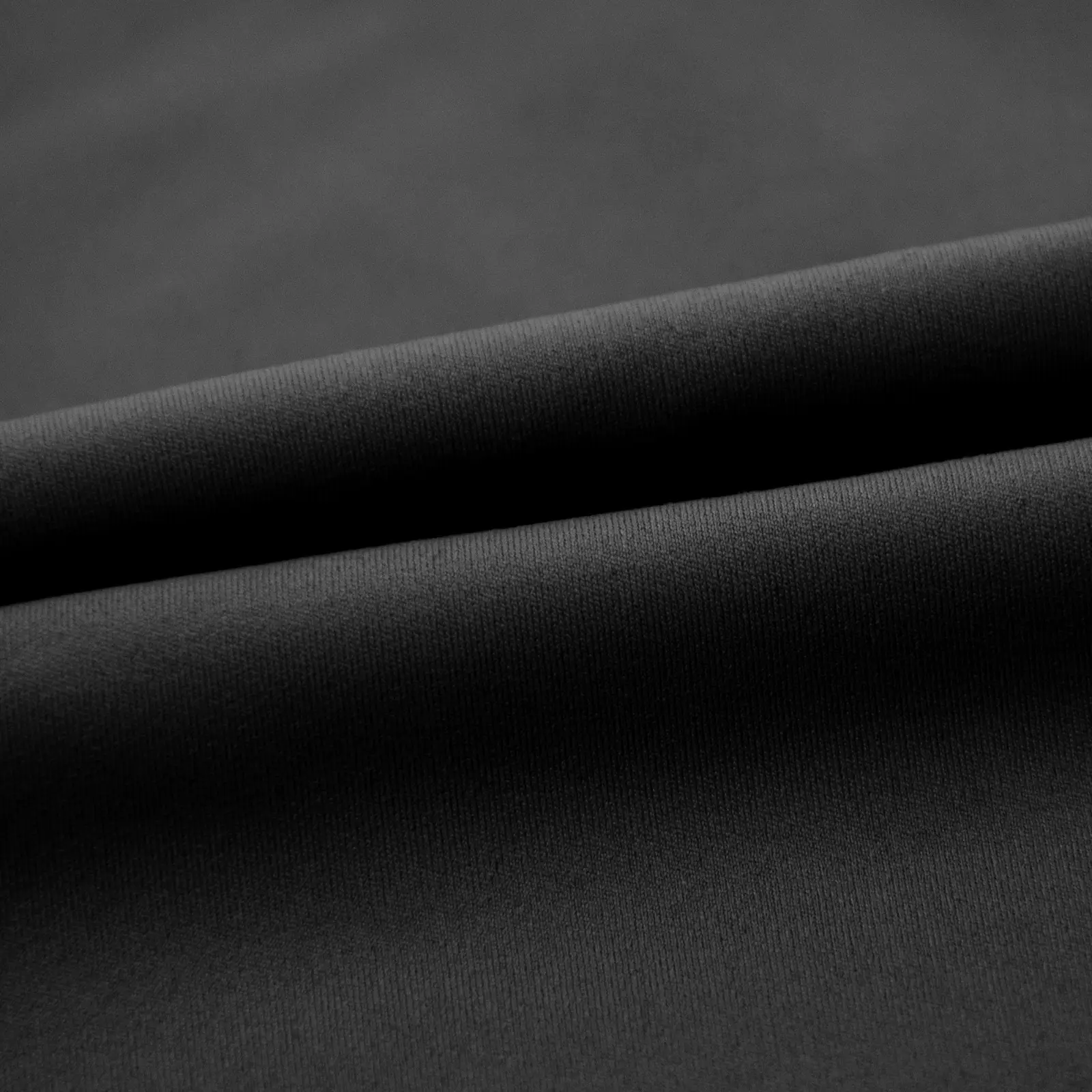 Close-up of folded black soft and smooth fabric
