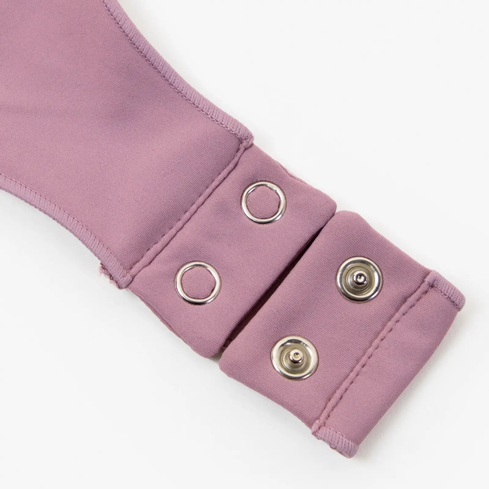 Close-up of light pink bodysuit thong snap-on closure