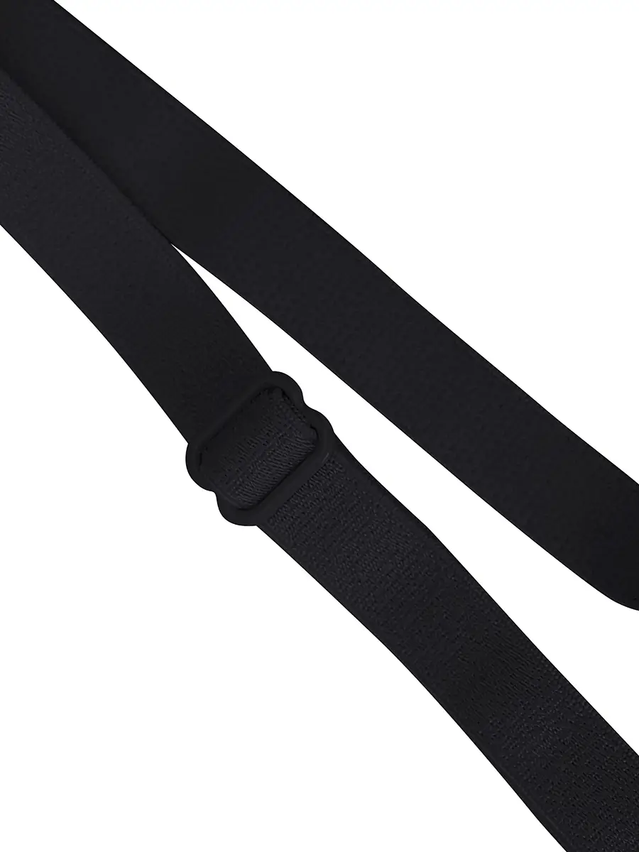 This image presents a detailed close-up view of a black fabric belt, isoated against a plain white background. The belt is...